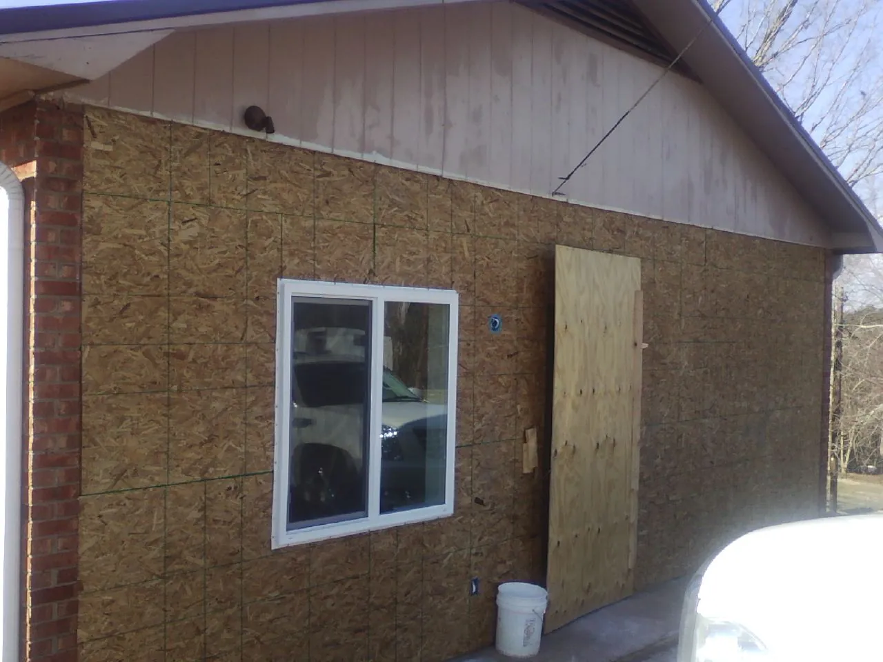 OSB sheathing on a garage addition wall before siding in Montezuma